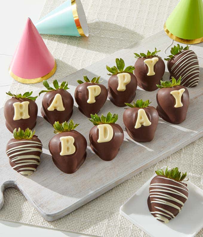 Edible arrangement featuring 12 fresh strawberries with a birthday edible message, dipped in Belgian chocolate.