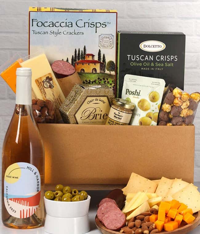 An abundent gift box filled with California Ros&eacute; Wine, assorted crackers, two cheeses, summer sausage, and snacks to make an amazing charcuterie spread. 