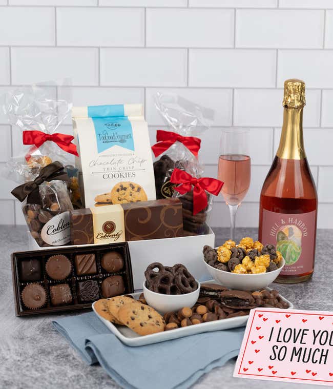 A gift set featuring a bottle of California Sparkling Wine paired with chocolate-covered pretzels, mini cookies, caramel popcorn, chocolate peanut butter buckeyes, 6 chocolate-covered Oreos, a box of assorted chocolates, and I Love You card.