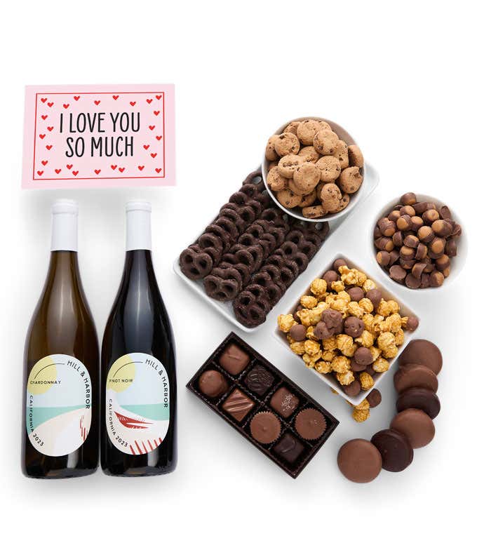 A gift set with 2 bottles of wine - red and white, paired with chocolate pretzels, caramel popcorn, mini cookies, chocolate peanut butter buckeyes, six chocolate-covered Oreos, assorted chocolates, and a touching I Love You card.