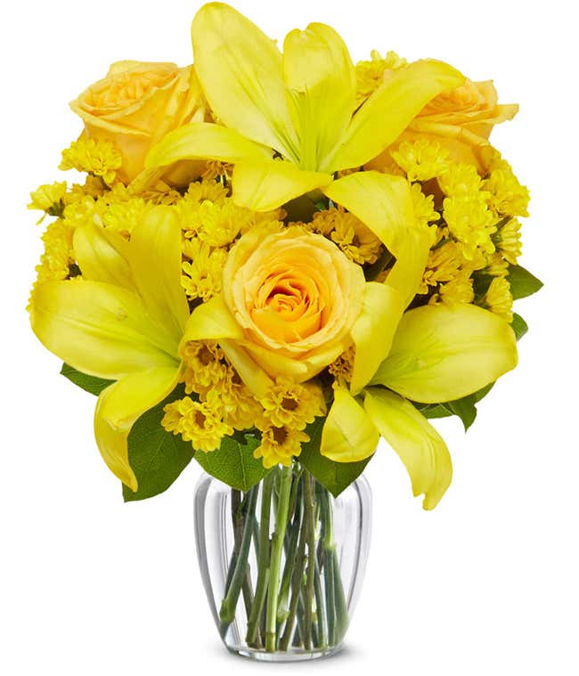 A bouquet featuring yellow lilies, yellow roses, and yellow poms, with an optional glass vase.