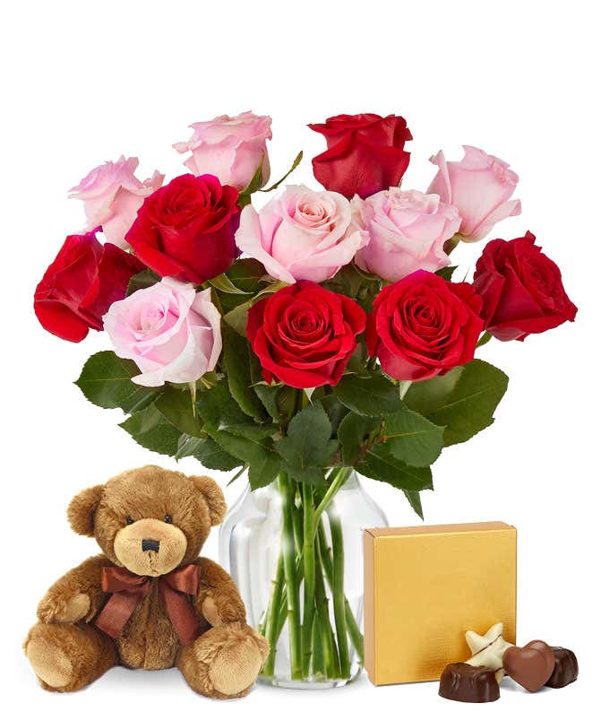 Pink and red roses with chocolates and a bear