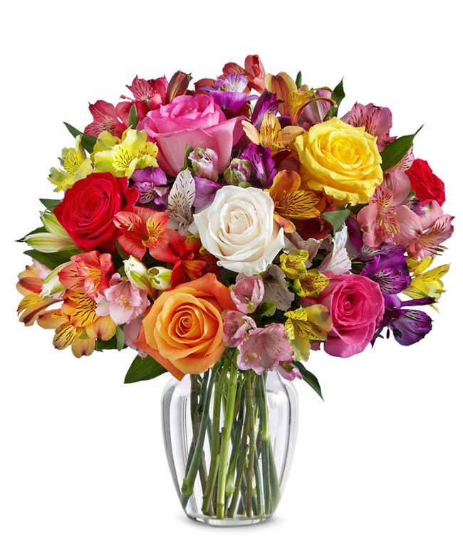 A beautiful arrangement featuring mixed roses and assorted alstroemeria, optionally presented in a glass vase. This vibrant mix offers a colorful and cheerful display, perfect for any occasion.