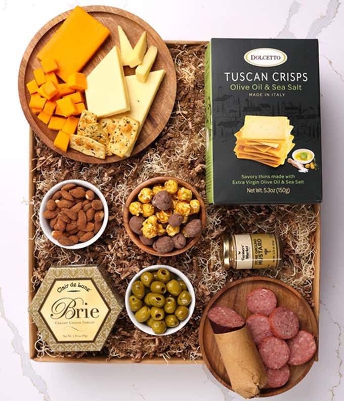 A gourmet charcuterie gift set featuring Tuscan crisps, focaccia crackers, smoked cheddar, garlic & onion cheese, brie spread, olives, mustard, almonds, chocolate-covered popcorn, and summer sausage.  Perfect for entertaining.