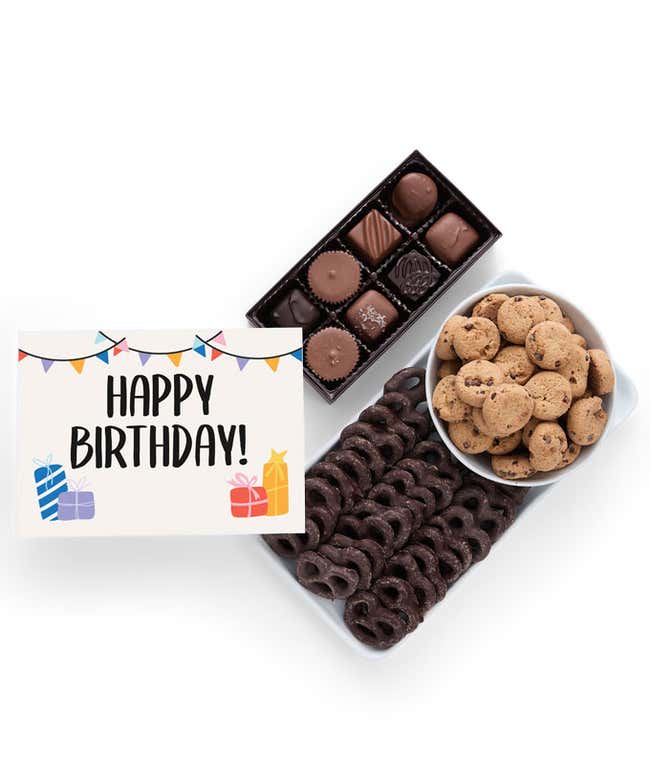 A selection of sweet treats, including a box of assorted chocolates, a box of mini chocolate chip cookies, and a bag of chocolate-covered pretzels accompanied by a Birthday message card for a personal touch.