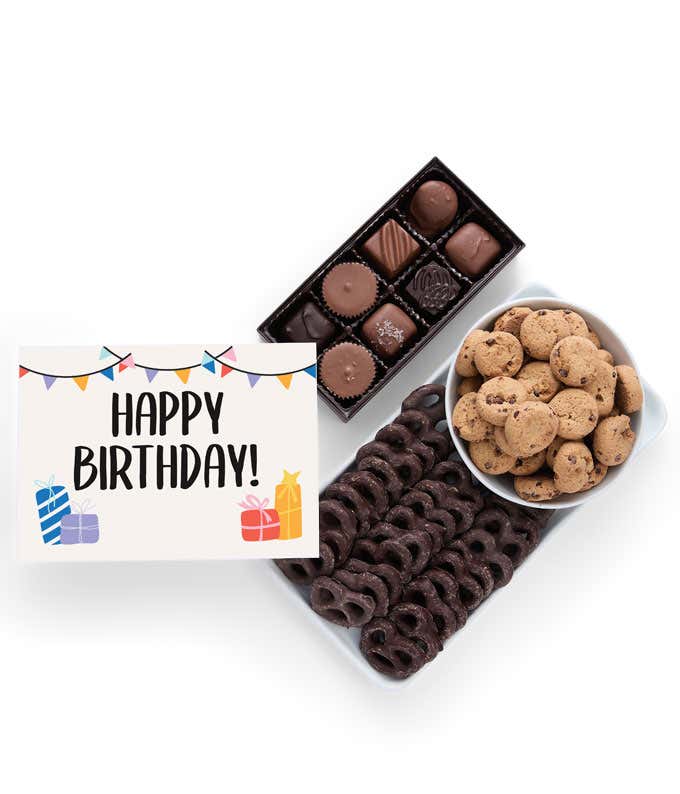 A selection of sweet treats, including a box of assorted chocolates, a box of mini chocolate chip cookies, and a bag of chocolate-covered pretzels accompanied by a Birthday message card for a personal touch.