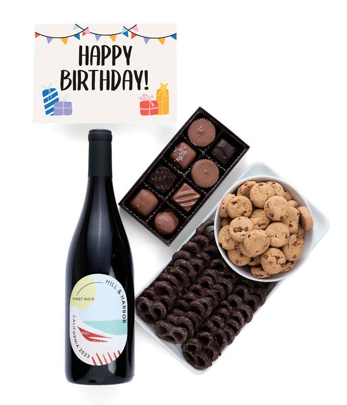 a gift box full of decadent treats with a Birthday message card.  Contents include: a bottle of California Pinot Noir, a bag of milk chocolate pretzel, a box of mini chocolate chip cookies, and a 4-ounce box of assorted chocolates.
