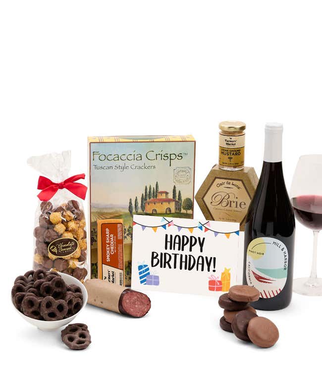 A gift set featuring a bottle of California Pinot Noir, focaccia crisps, two cheeses, mustard, summer sausage, caramel popcorn, chocolate pretzels, six chocolate-covered Oreos and a Birthday card to complete the gourmet experience.